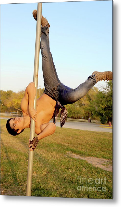 Body Metal Print featuring the photograph Handsome young hispanic man shows off some pole dance moves by Gunther Allen