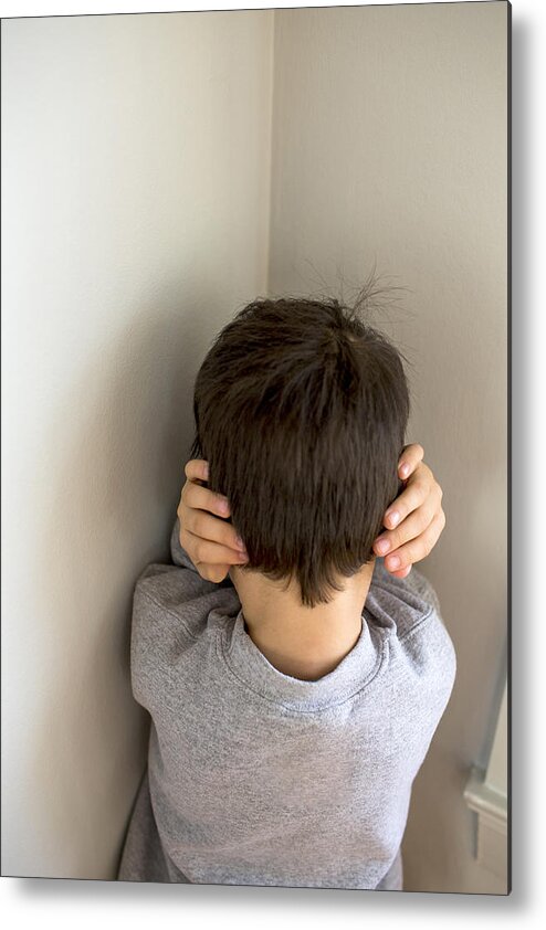 Toddler Metal Print featuring the photograph Mixed Race boy standing in corner covering ears by Adam Hester