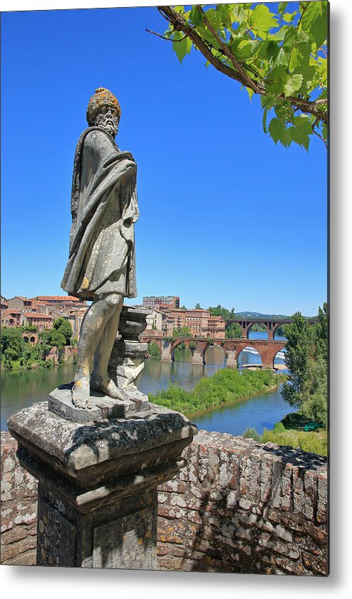 Tranquility Metal Print featuring the photograph Statue in the formal gardens of the Palais de Berbie in Albi, France. by David Forman