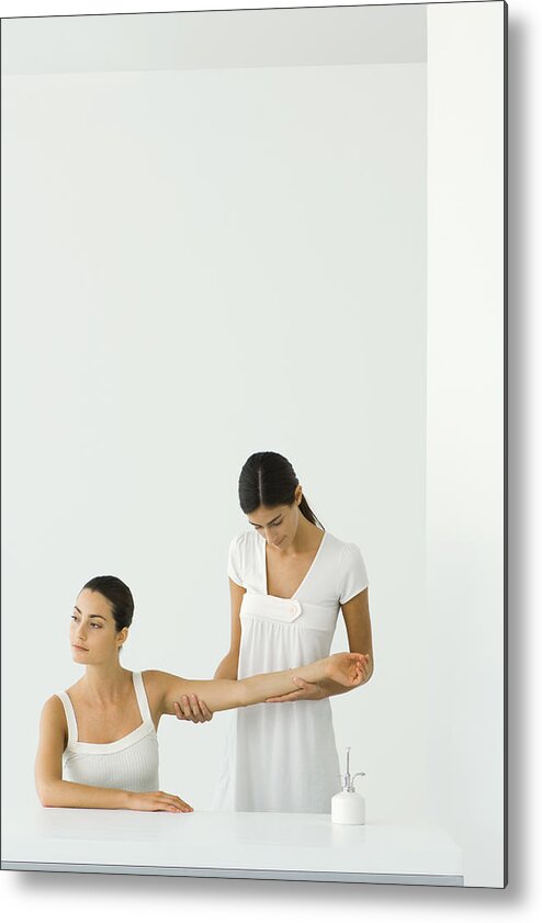 Relief Metal Print featuring the photograph Woman receiving arm massage, looking away by ZenShui/Milena Boniek