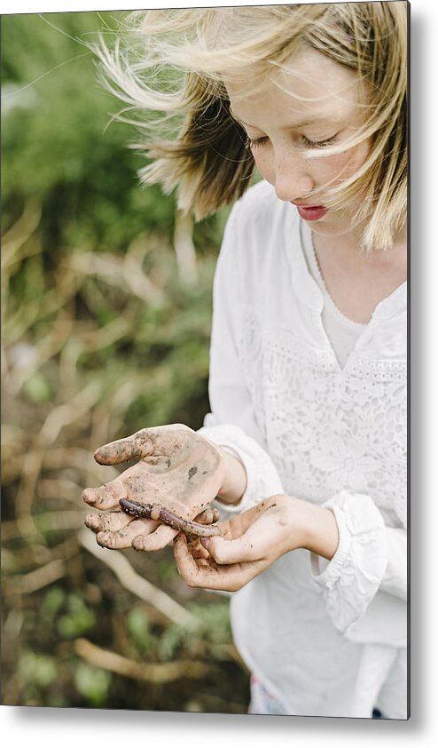 Insect Metal Print featuring the photograph Young Girl Learning and Playing With An Earthworms in Her Kitchen Garden. by ClarkandCompany