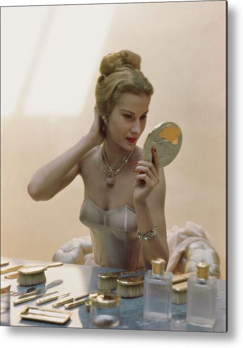 Beauty Metal Print featuring the photograph A Model At A Dressing Table by John Rawlings