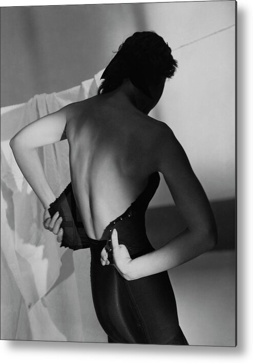 Fashion Metal Print featuring the photograph A Model Fastening Her Brassiere by Horst P. Horst