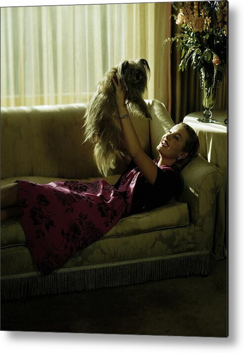 Model Metal Print featuring the photograph A Model Holding A Dog by Constantin Joffe