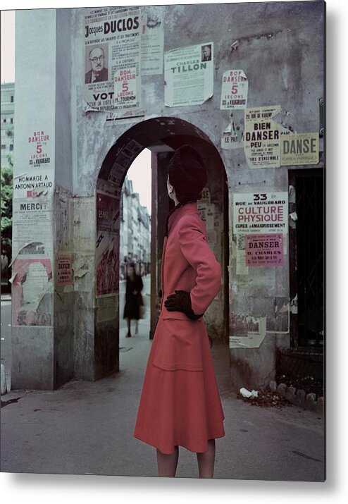 Accessories Metal Print featuring the photograph A Model Wearing A Red Coat On A Street In Paris by John Rawlings