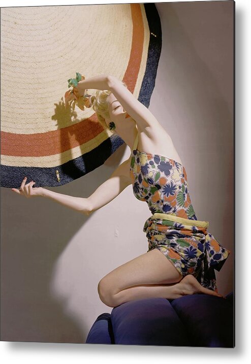 Fashion Metal Print featuring the photograph A Model Wearing A Swimsuit And Holding An by Horst P. Horst