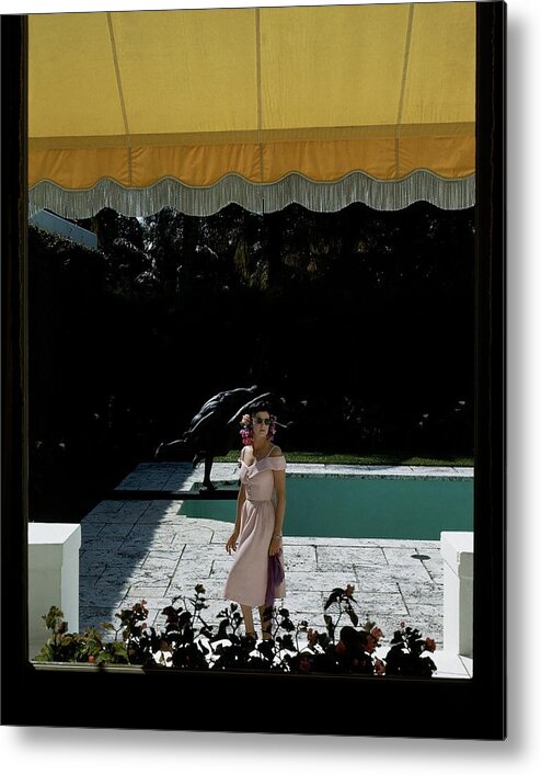Fashion Metal Print featuring the photograph A Woman Walking Beside Her Swimming Pool by John Rawlings