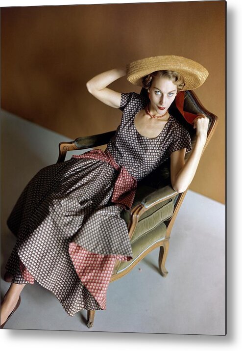 Accessories Metal Print featuring the photograph A Woman Wearing A Patterned Dress Sitting In An by Horst P. Horst