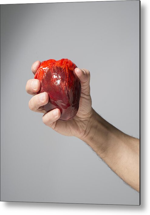 Mature Adult Metal Print featuring the photograph Heart in hand by PM Images