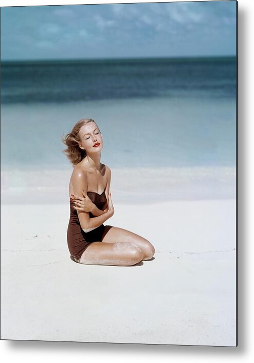 Fashion Metal Print featuring the photograph Liz Benn Sitting On A Beach by John Rawlings