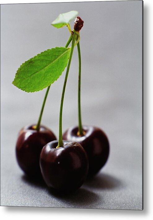 Fruits Metal Print featuring the photograph Three Cherries On A Stem by Romulo Yanes