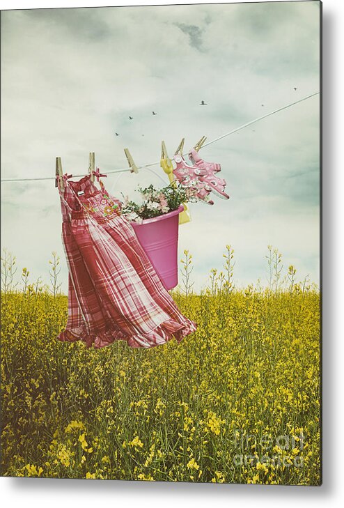 Atmosphere Metal Print featuring the photograph Child's dress and toys hanging on line with farmhouse in backgro #2 by Sandra Cunningham