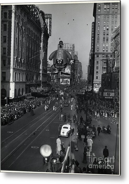Crowd Of People Metal Print featuring the photograph Balloon In Macys Thanksgiving Day Parade by Bettmann
