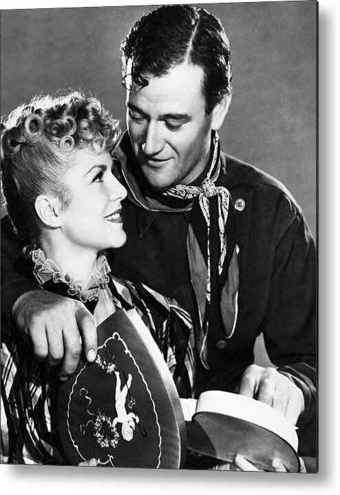 Claire Trevor Metal Print featuring the photograph JOHN WAYNE and CLAIRE TREVOR in STAGECOACH -1939-. by Album
