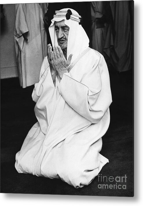 People Metal Print featuring the photograph King Faisal Kneels In Prayer by Bettmann