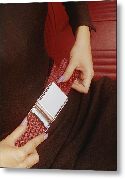 People Metal Print featuring the photograph Woman Fastening His Seatbelt, Close-up by Tom Kelley Archive