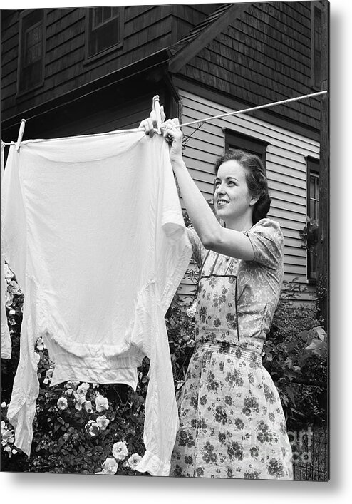 Hanging Metal Print featuring the photograph Woman Hanging Laundry Out To Dry by Bettmann