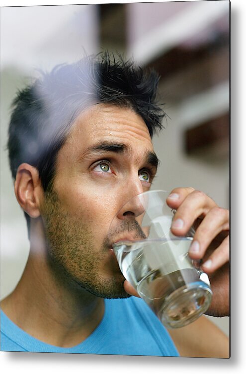 People Metal Print featuring the photograph Man drinking glass of water, view through window, close-up by Michael Blann