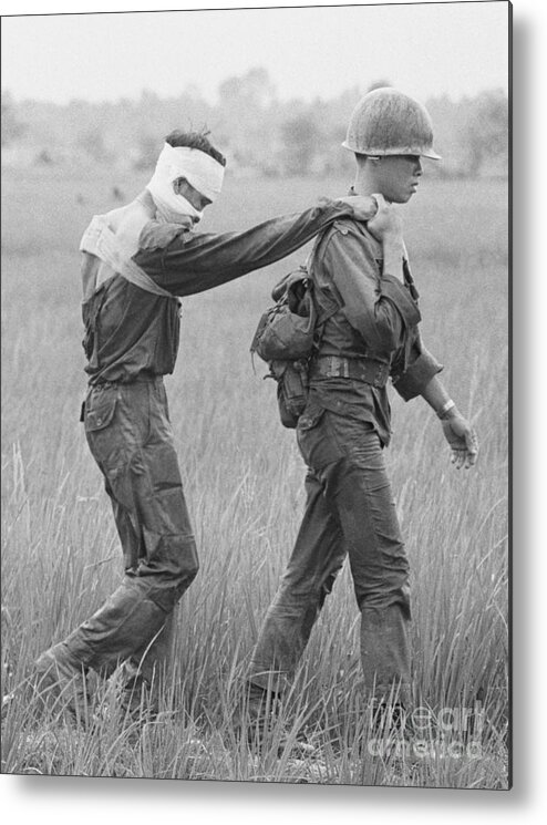 Vietnam War Metal Print featuring the photograph A Wounded Soldier Being Lead by Bettmann