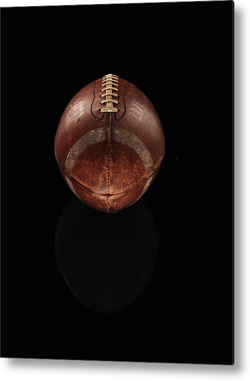 American Football Metal Print featuring the photograph Old Football On Black Background by Alexander Nicholson