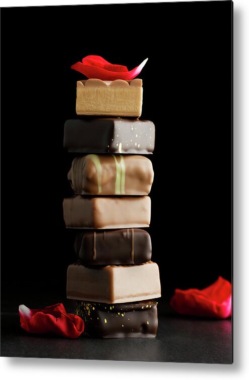 Black Background Metal Print featuring the photograph Tower Of Chocolates With Rose Petals On by Sabine Scheckel