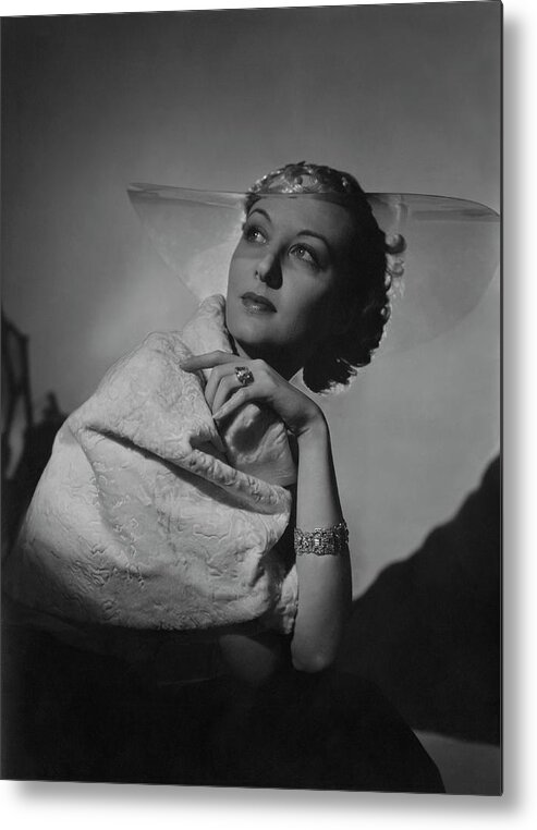 Fashion Metal Print featuring the photograph A Model Wearing A Coat And Glass Hat by Horst P. Horst