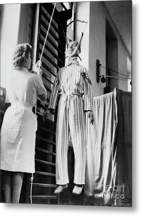 Hanging Metal Print featuring the photograph Man With Paralysis Hanging For Treatment by Bettmann