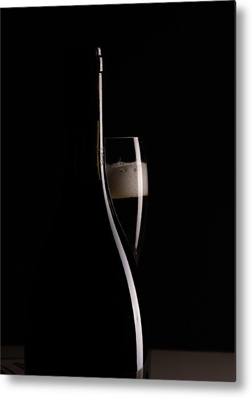 Red Wine Metal Print featuring the photograph Red sparking wine on a wineglass and black wine bottle. by Michalakis Ppalis