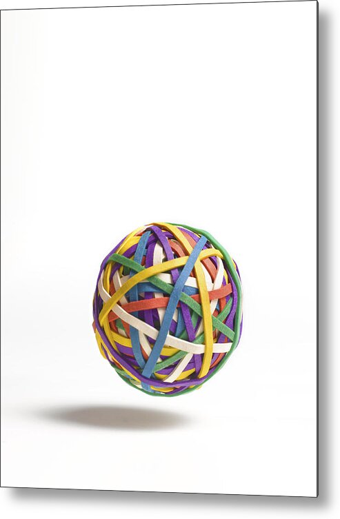 White Background Metal Print featuring the photograph Bouncing ball of elastic bands by Peter Dazeley