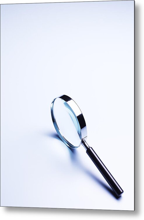 Magnifying Glass Metal Print featuring the photograph Magnifier on pale blue background with copy space by Peter Dazeley