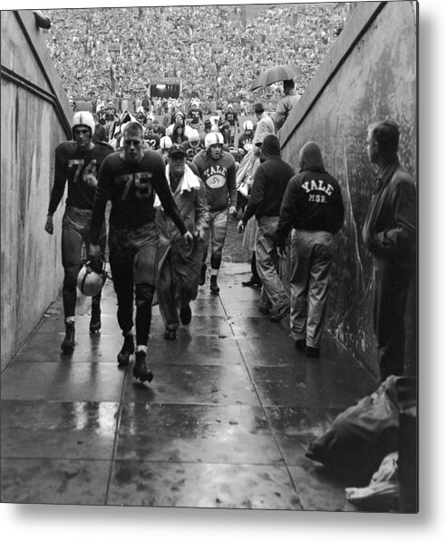 Crowd Metal Print featuring the photograph Yale Football Team Leaves Field by Getty Images