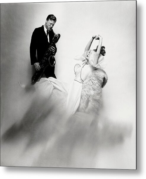Fashion Metal Print featuring the photograph Jazz Musician Gerry Mulligan and model Monique Chevalier by Bert Stern