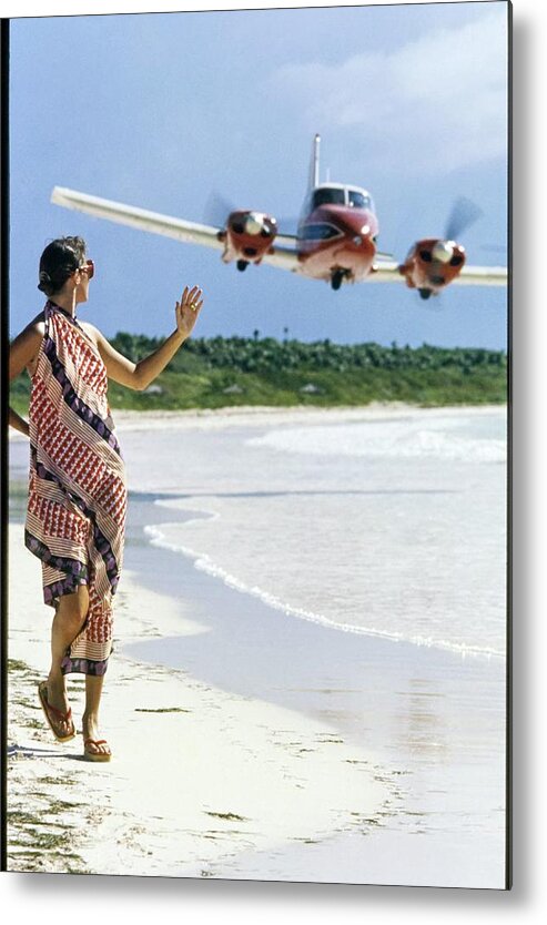 Caribbean Model Beach Airplane Bahamas Atlantic Islands Out Islands 1970s Style Outdoors Daytime One Person People Fashion Model Clothing 20-24 Years Young Adult 20s Adult Woman Young Woman Young Adult Woman Brunette Dark Hair Dress Sand Sea Water Transportation Travel Aircraft Passenger Plane Commercial Airplane Aviation Jet Plane Flying Waving Looking Over Shoulder Walking Scarf Dress Lanvin Flip Flops Footwear Sunglasses Eyewear Overcast Overcast Sky Selective Focus #condenastvoguephotograph #condenastvoguephotograph December 1st 1972 Metal Print featuring the photograph Model Wearing A Lanvin Dress by Kourken Pakchanian