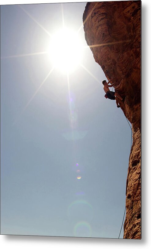 Recreational Pursuit Metal Print featuring the photograph A Rock Climber Ascends A Red Rock Face #28 by Jared Mcmillen