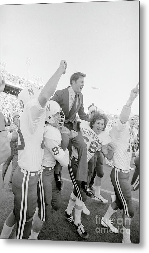 People Metal Print featuring the photograph Teammates Carrying Coach Tom Osborne by Bettmann