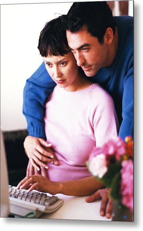Mid Adult Women Metal Print featuring the photograph Pregnant woman using computer, man hugging her by John Dowland