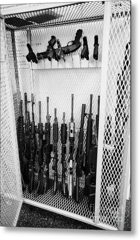 Cage Metal Print featuring the photograph Cage Of Assault Rifles Handguns And Shotguns At A Gun Range In Las Vegas Nevada Usa by Joe Fox