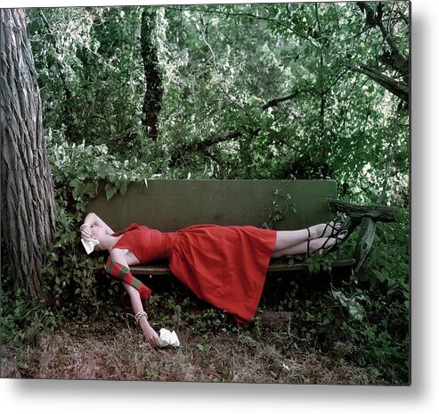 Accessories Metal Print featuring the photograph A Woman Lying On A Bench by John Rawlings
