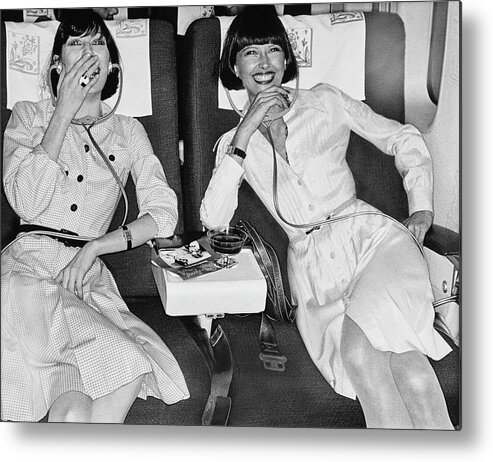 Fashion Metal Print featuring the photograph Two Models Laughing At A Movie In An Iberia 747 by Chris von Wangenheim