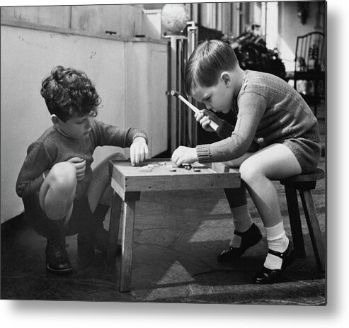 Two People Metal Print featuring the photograph Two Young Boys Sitting By A Wooden Table by Remie Lohse