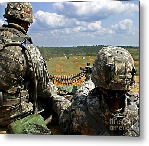 Camp Shelby Metal Print featuring the photograph Soldier Feeds Ammunition To His Gunner by Stocktrek Images