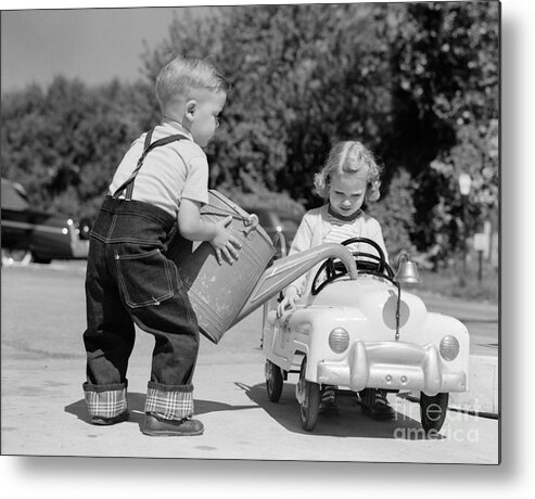 1950s Metal Print featuring the photograph Boy Playing Gas Station Attendant by H. Armstrong Roberts/ClassicStock