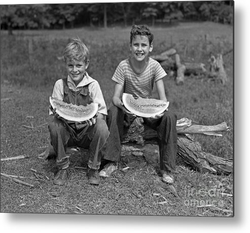 1940s Metal Print featuring the photograph Boys Eating Watermelons, C.1940s by H. Armstrong Roberts/ClassicStock