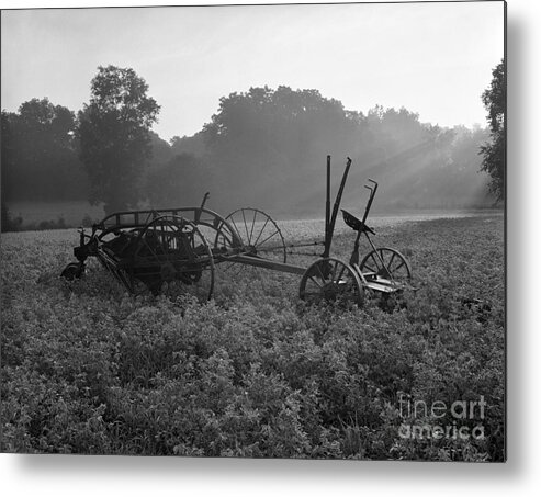 Agriculture Metal Print featuring the photograph Old Hay Baler In Misty Field by H Armstrong Roberts and ClassicStock