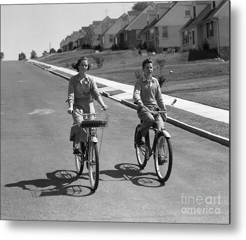 1950s Metal Print featuring the photograph Teen Boy And Girl Riding Bikes, C.1950s by H. Armstrong Roberts/ClassicStock