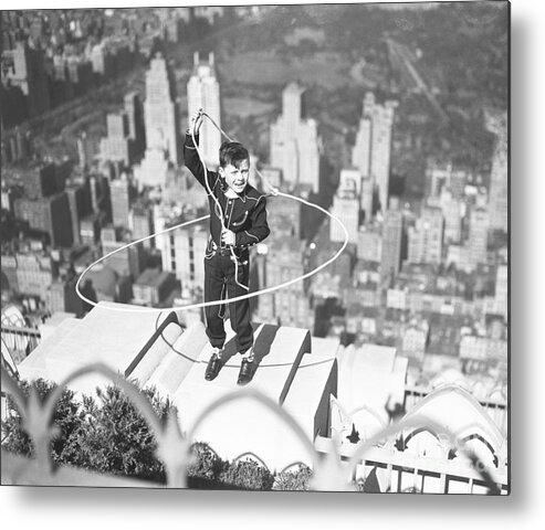 Child Metal Print featuring the photograph Boy On Ledge Twirling A Lasso by Bettmann