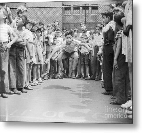 Child Metal Print featuring the photograph Teenage Boy Does Standing Broad Jump by Bettmann