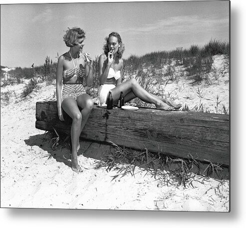 Grass Metal Print featuring the photograph Two Women In Bikini Eating Snack On by George Marks