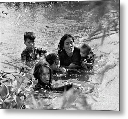 Mid Adult Women Metal Print featuring the photograph Vietnamese Mother And Children Flee by Bettmann