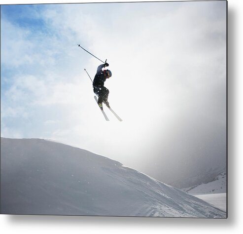 Ski Pole Metal Print featuring the photograph Young Male Skier Mid-air, Rear View by Paul Bradbury